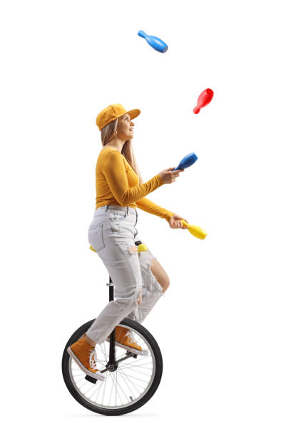 istock Young female riding a unicycle and juggling 1391218812