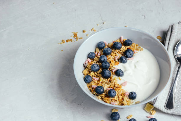 istock Yogurt with muesli and berries on a gray background. 1391220563