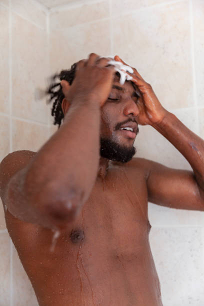 istock Positive man used shampoo while taking hot shower 1391221682