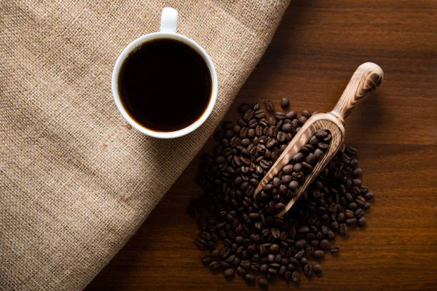 istock White cup of filter coffee with coffee beans on wooden background 1391221786