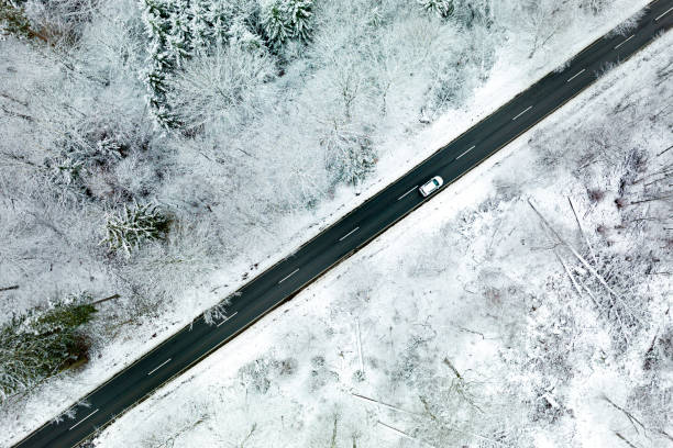 istock Road through wintery landscape - aerial view 1391221793