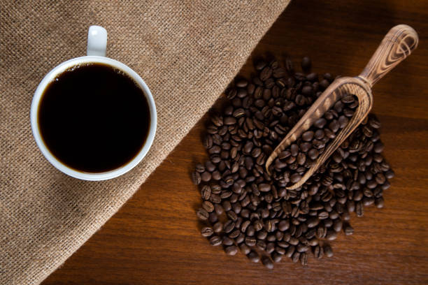 istock White cup of filter coffee with coffee beans on wooden background 1391223169