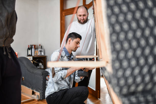istock Friends Helping Male Drill Screw Holes In Bed While Redecorating 1391224395