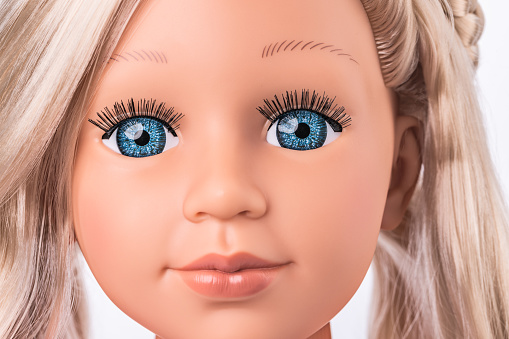 Make-up and hairdressing head of a beautiful doll with real skin and face expression