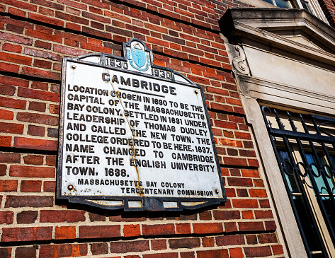 Cambridge, Massachusetts, USA - April 10, 2022: 1930 marker of the 300th anniversary of Cambridge being chosen as Massachusetts Bay Colony capital in 1630. Located on Dunster Street in Harvard Square.