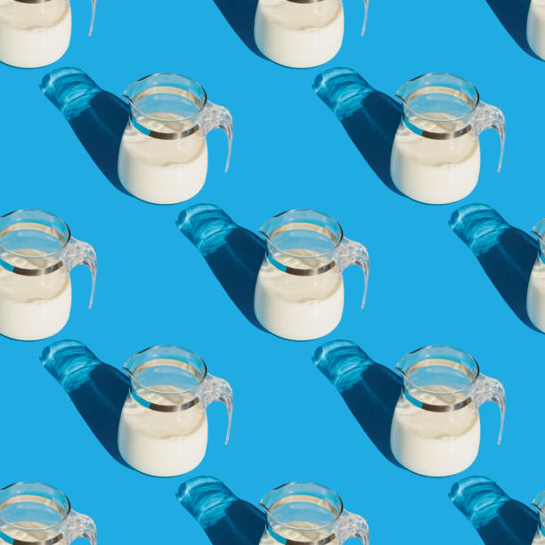 istock A jug of white fresh milk on a blue background. Seamless pattern 1391229508