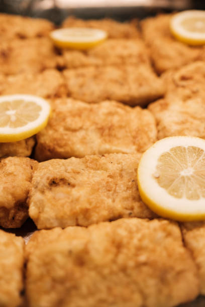 fried  Hake fillets with lemon on a tray in a take away restaurant