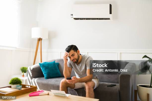 Sad Man Feeling Hot Without The Air Conditioner Stock Photo - Download Image Now - Sweat, Air Conditioner, Heat - Temperature
