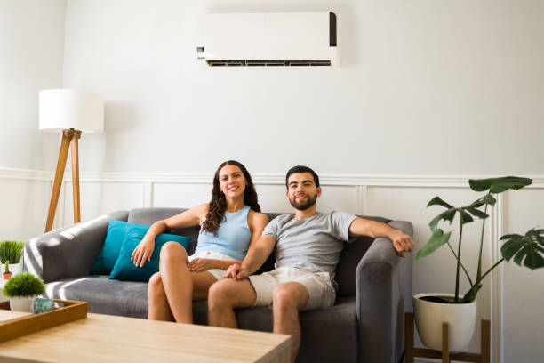 istock Attractive couple with an ac unit at home 1391232719