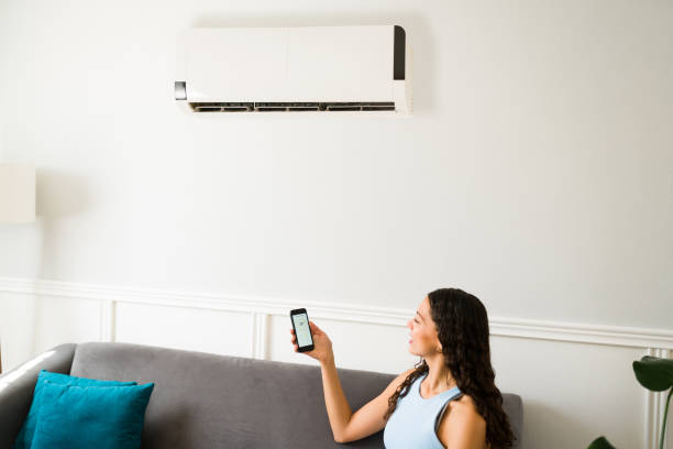 istock Young woman turning on the ac 1391232938