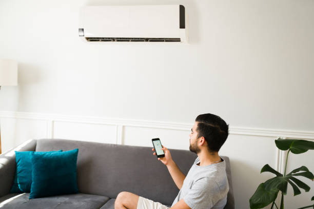 istock Young man turning on the ac during a heat wave 1391233440