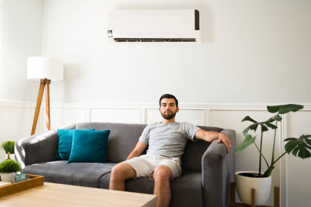 istock Man enjoying air conditioning at home 1391233675