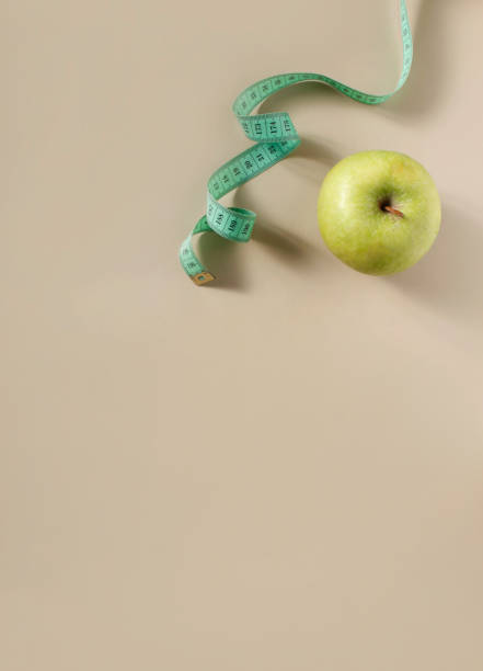 istock Diet concept. Apple with measuring tape 1391233816