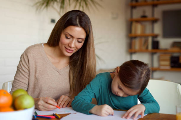 istock Mother spending quality time with her daughter teaching her to draw 1391233923