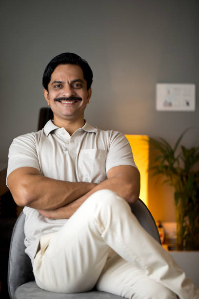istock Confident man sitting at home 1391235300