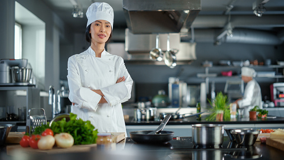 two pans cooking broth in a professional kitchen.