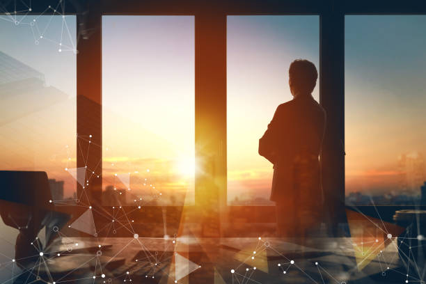 istock Man is standing near window in office 1391239431