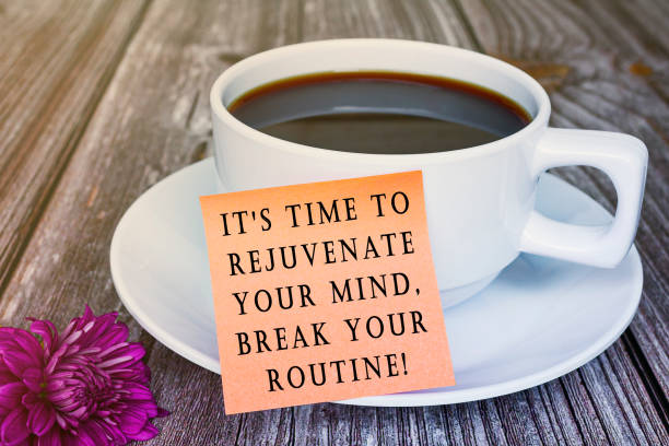 istock Motivational quote written on sticky note with white coffee cup and flowers. 1391240044