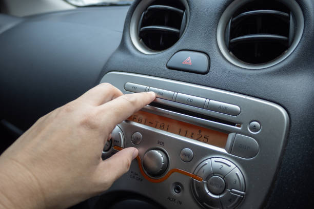 istock the finger press on the button at the control panel for play music in car 1391242143