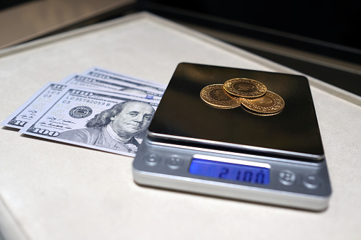 Gram gold coins weighed on precision digital scales