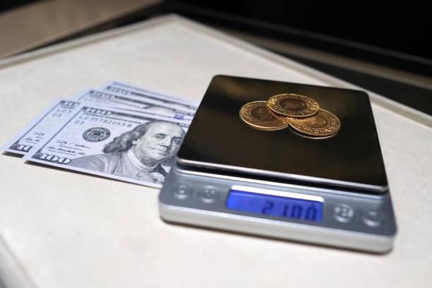 Gram gold coins weighed on precision digital scales stock photo