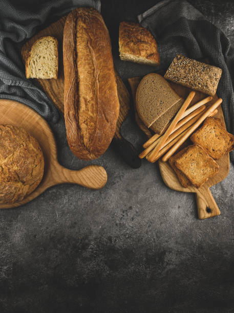 istock Selection of bread and loaf with cereals bread, breadsticks on a gray rustic concrete table with copy space 1391242485