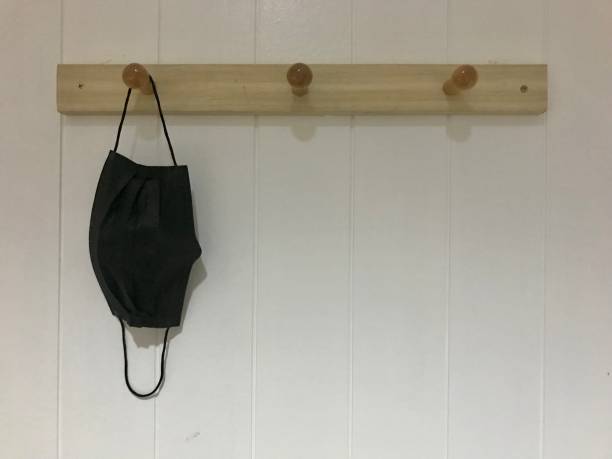 istock Surgical mask hang on white wall 1391242817