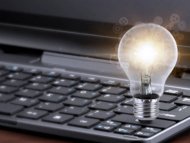 istock Laptop and glowing light bulb. Self learning or education knowledge and business studying concept. Idea of learning online or e-learning from home 1391245119