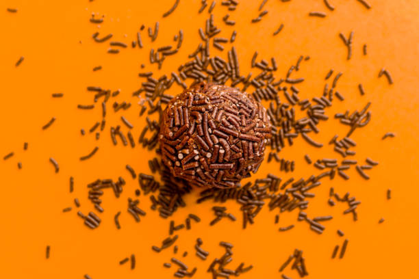 istock Brigadeiro isolated on orange background, top view. 1391245237