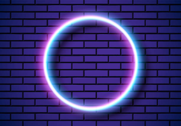 istock Neon frame with circle shape on the blue brick wall. Classic round 80s styled purple shiny glowing neon sign. 1391245245