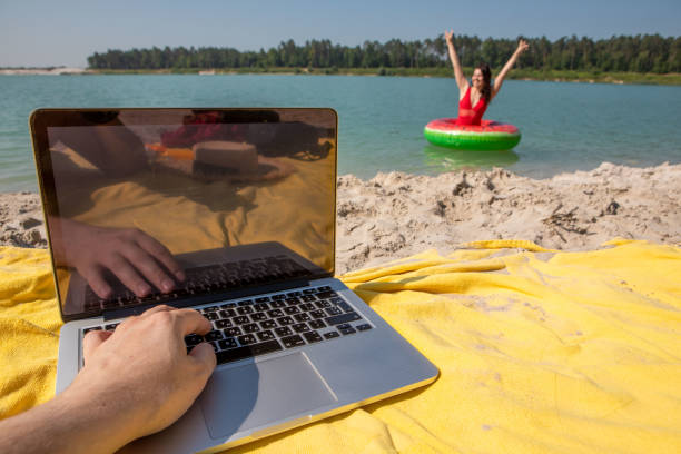 istock freelancer concept working on laptop at sandy beach 1391246996