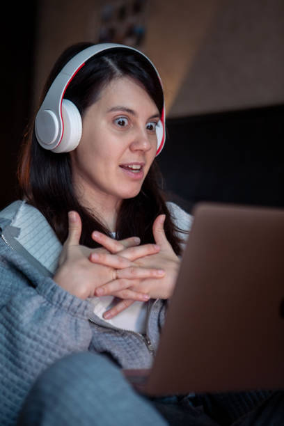 istock woman in headset working on laptop has video call 1391247027