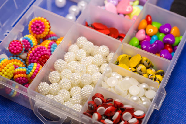 istock Plastic box with small accessories for needlework in separate cells on a blue background 1391247353