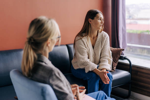 istock Sad frustrated woman talking in a session with a psychotherapist about her problems. 1391247455