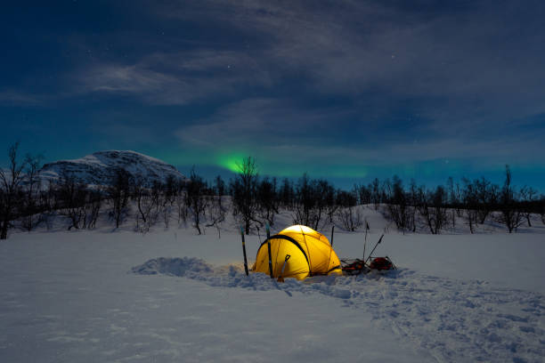 istock Northern lights over a tent 1391248890