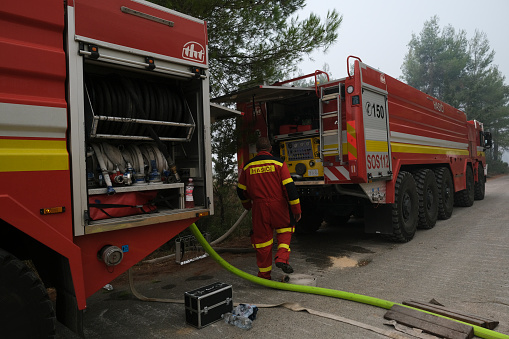 Czech firefighters try to extinguish the burning blaze of a forest fire near in the village of Avgaria on the Greek island of Evia, August 10, 2021.