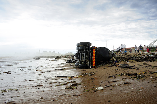 The photograph was taken on April 12th, 2022 in Durban, South Africa. A trailer has been washed away by a heavy storm, down the Umgeni River, ending up stranded at the Durban.
