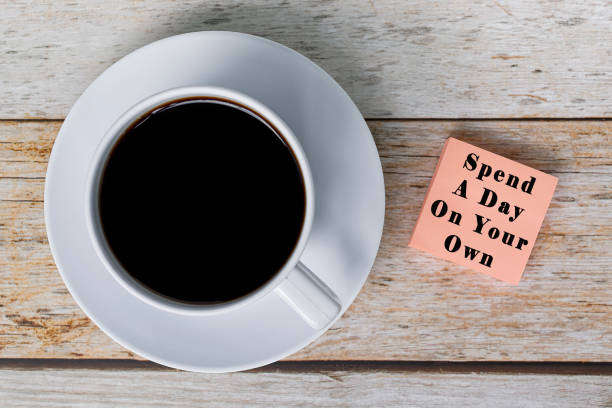 istock Motivational quote on notepad with white coffee cup on wooden desk. 1391251008