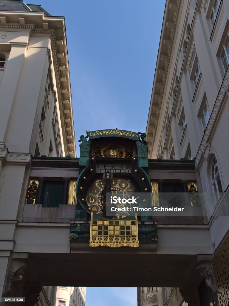 Low angle view of the historic music box Ankeruhr (Jugendstil, completed 1915) in the old downtown of Vienna, Austria. Low angle view of the historic music box Ankeruhr (Jugendstil, completed 1915) in the old downtown of Vienna, Austria between two old buildings. Architecture Stock Photo