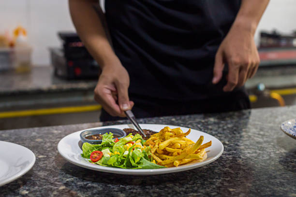 istock Chef prepering beef steak dish before serving to customer restaurant kitchen 1391252288