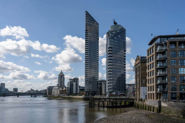 Modern apartment buildings on the River Thames in London on a sunny day.