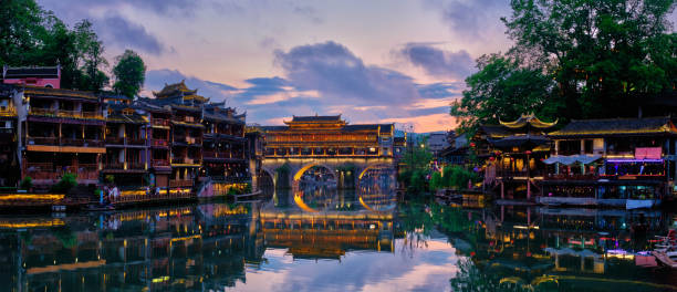 Feng Huang Ancient Town (Phoenix Ancient Town) , China Chinese tourist attraction destination - panorama of Feng Huang Ancient Town (Phoenix Ancient Town) on Tuo Jiang River illuminated at night. Hunan Province, China fenghuang county photos stock pictures, royalty-free photos & images