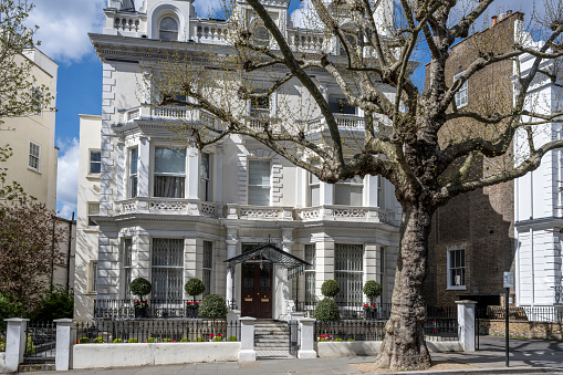 Facades of typical townhouses in Notting Hill on a sunny day.