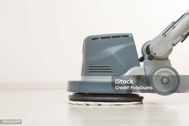 Professional Disc Machine With Microfiber Soft Pad Polishing And Waxing Light Laminate Floor Surface At Home Room Closeup Commercial Service Side View Stock Photo - Download Image Now
