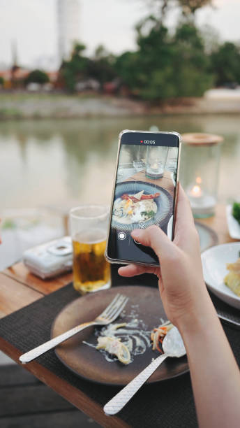 istock POV hand using digital device photographing vlog social media luxury dinner with river view in asia 1391259070