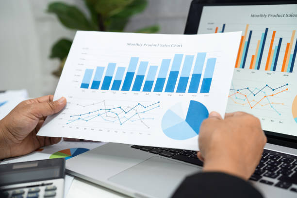 istock Asian accountant working and analyzing financial reports project accounting with chart graph and calculator in modern office, finance and business concept. 1391259242