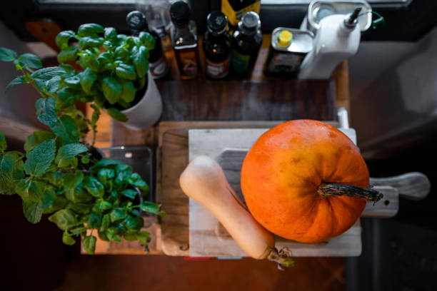 Directly above view of a meal is being prepared in Toulouse in the South of France. There're home grown herbs, a squash and a pumpkin.