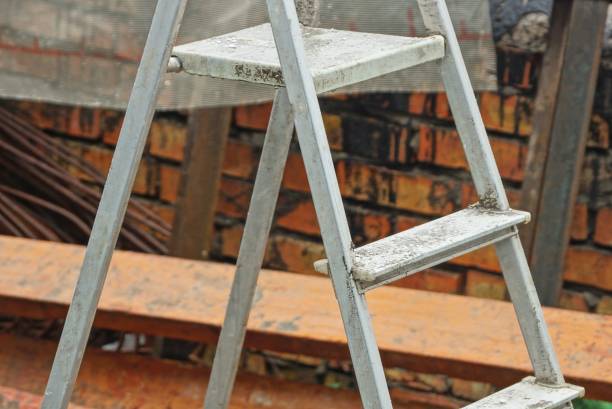istock one white folding aluminum ladder stands outside 1391263558