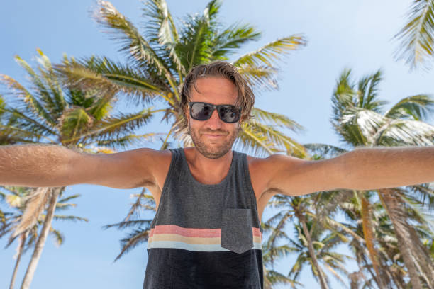 istock Man taking selfie on tropical vacation 1391264737