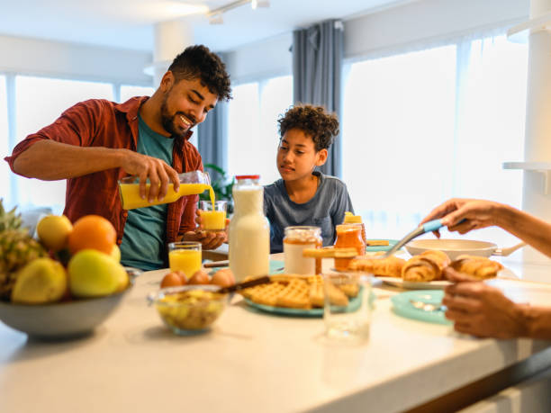 istock Happy black family having breakfast in the kitchen 1391265875